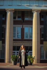 Girl throwing graduation cap into the air.
