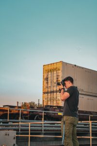 Man taking photo next to train